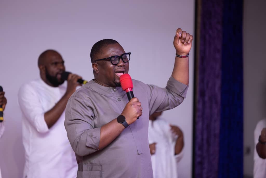 Bankole Francis leading worship service